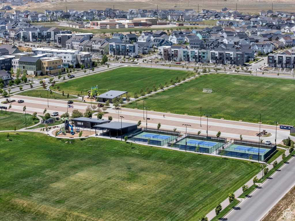 Aerial view of property and surrounding area with nearby suburban area