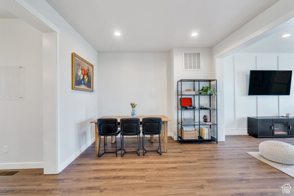 Dining area featuring wood finished floors, recessed lighting, and baseboards