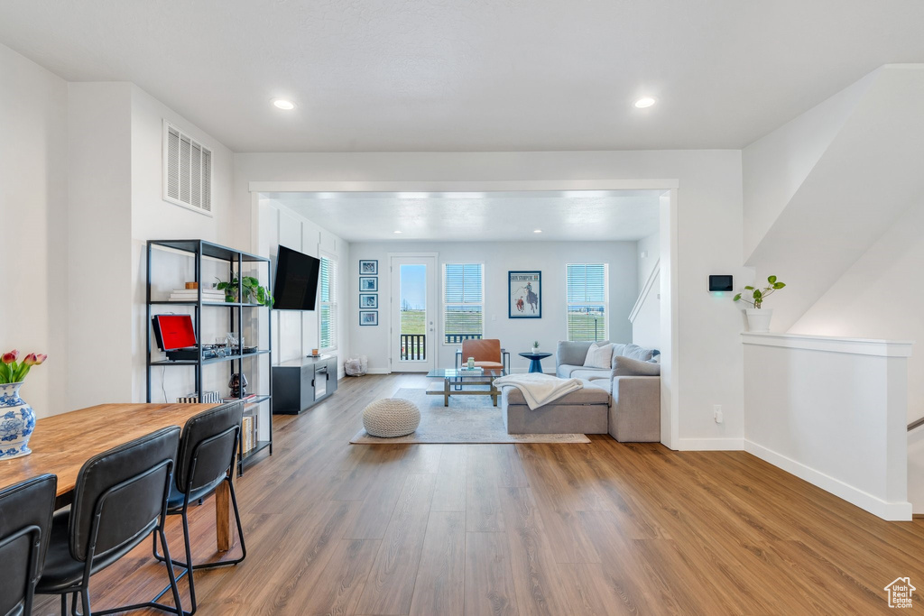 Living room with wood finished floors, recessed lighting, and baseboards