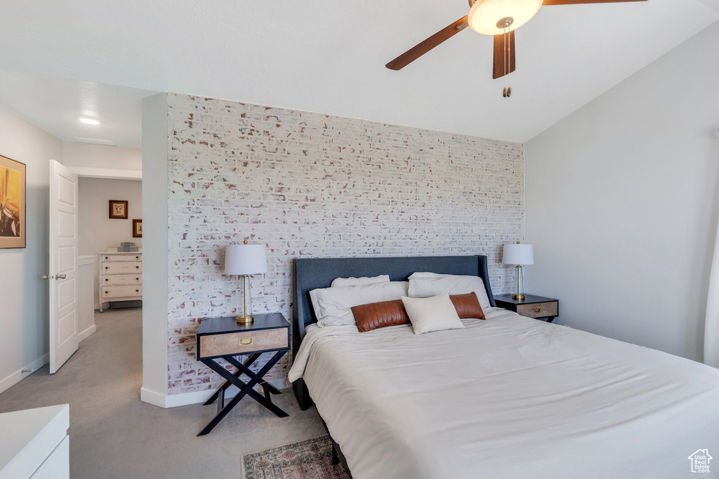 Bedroom featuring light carpet, baseboards, and a ceiling fan