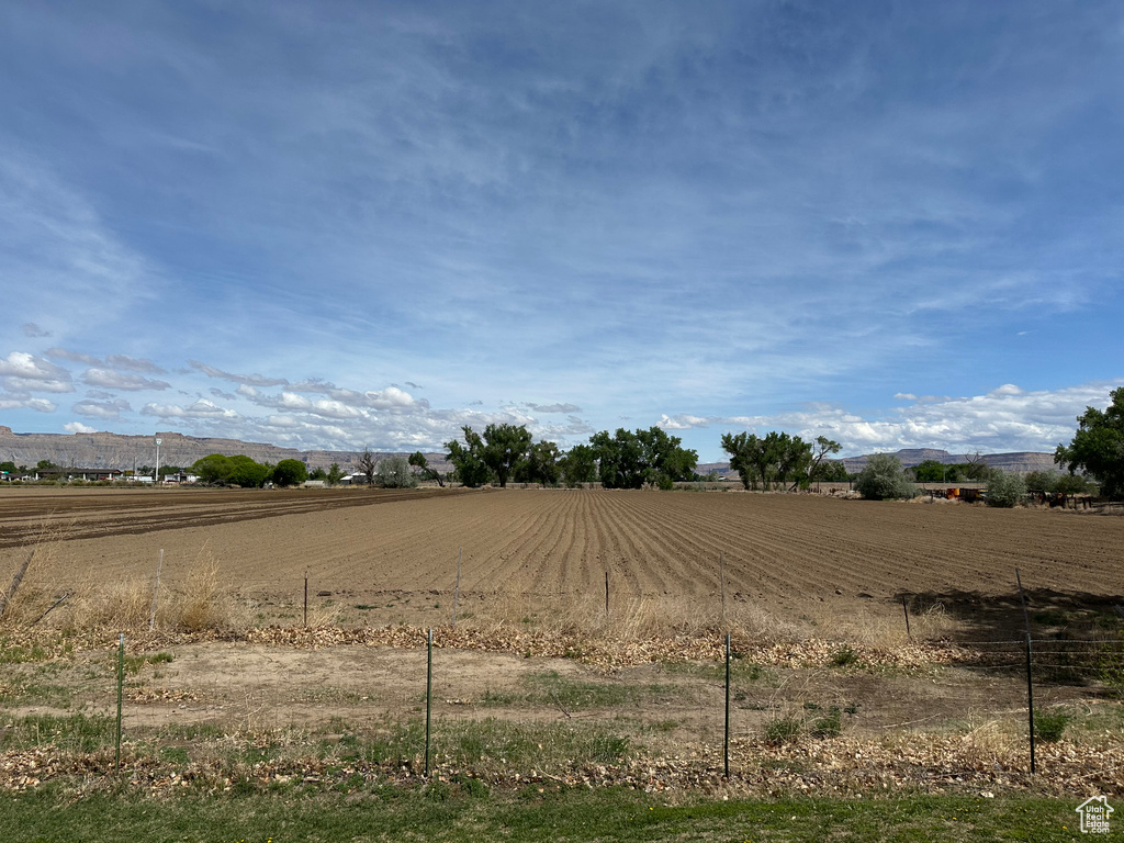 View of yard featuring a rural view and an enclosed riding area