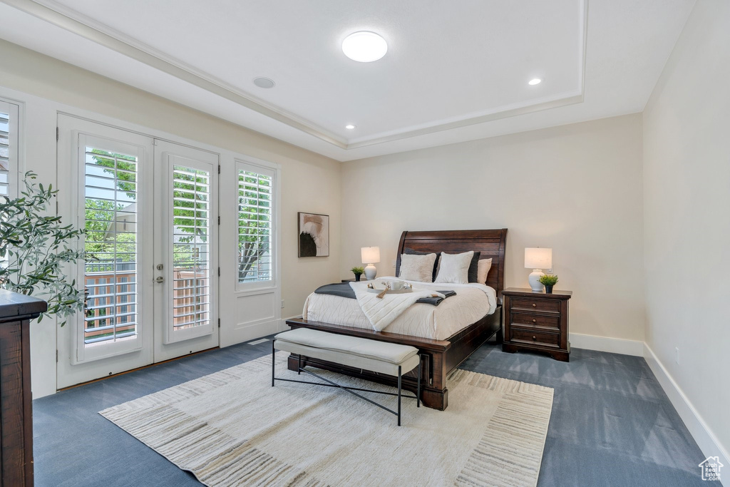 Carpeted bedroom with french doors, access to exterior, baseboards, a tray ceiling, and recessed lighting