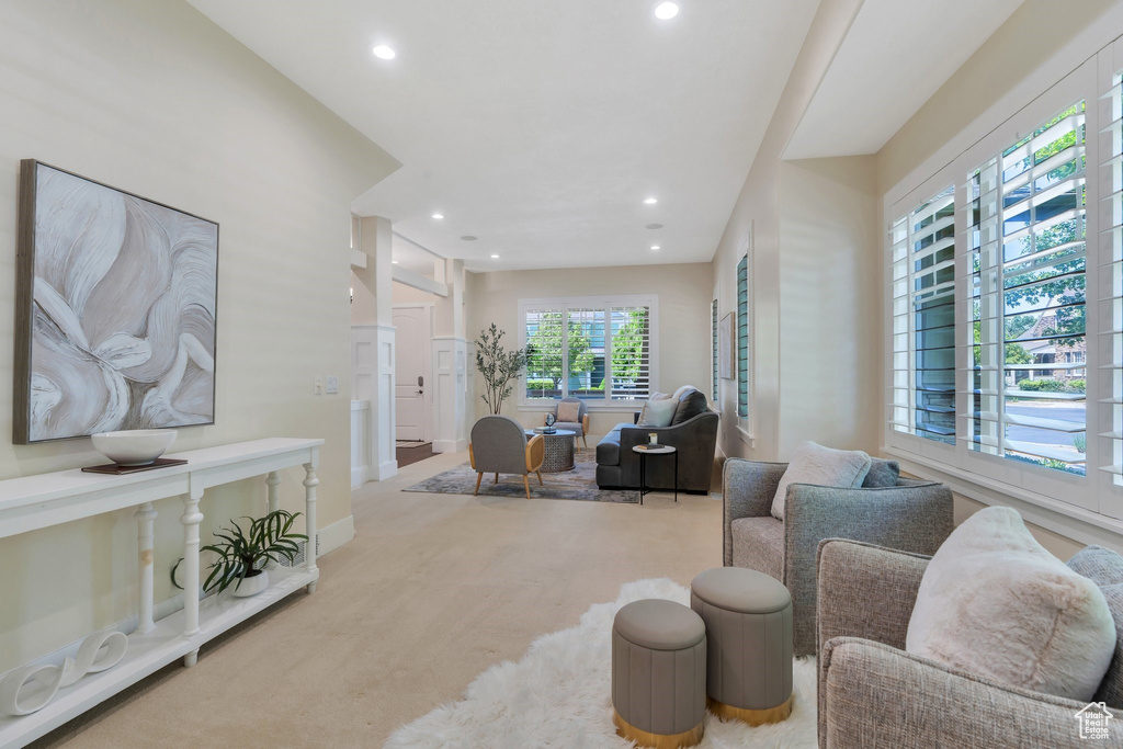 Carpeted living room featuring recessed lighting and baseboards