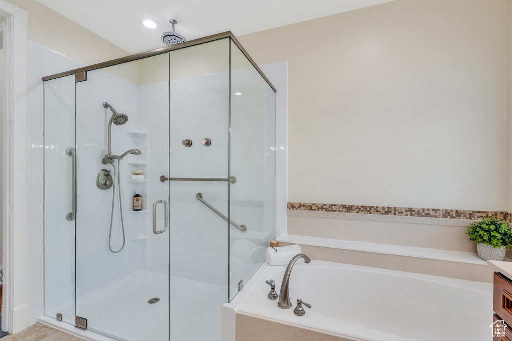 Full bath featuring a shower stall and a bath