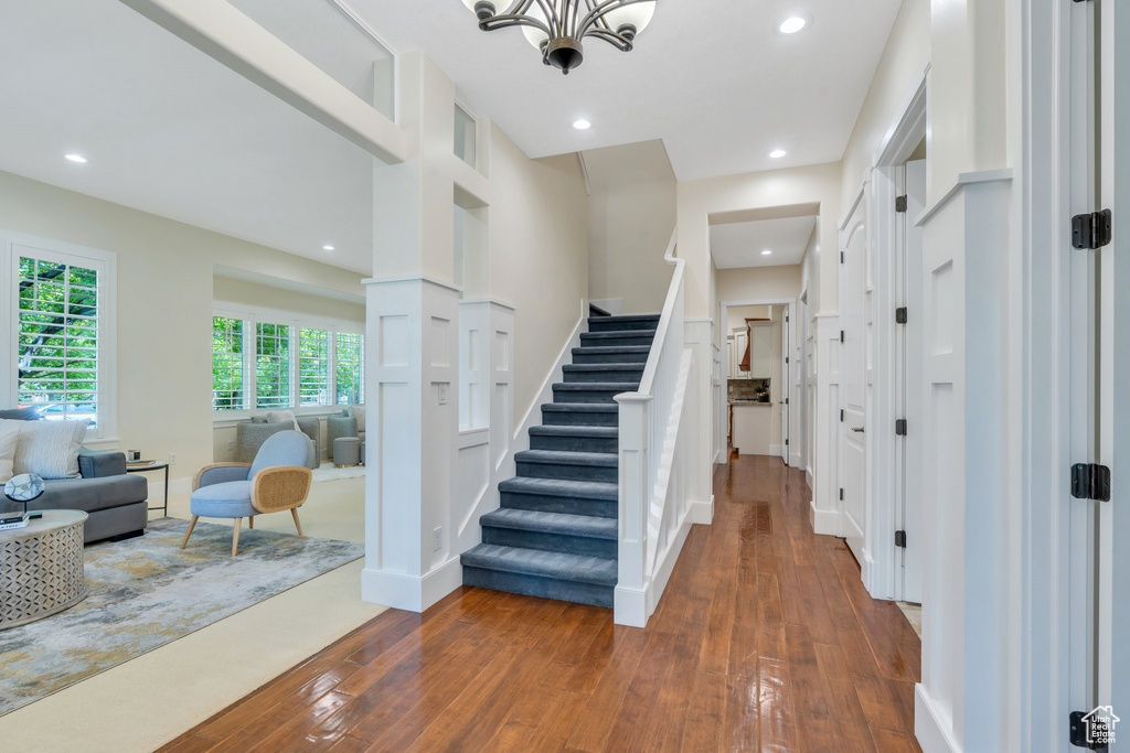 Foyer entrance featuring hardwood / wood-style flooring, stairs, recessed lighting, and a chandelier