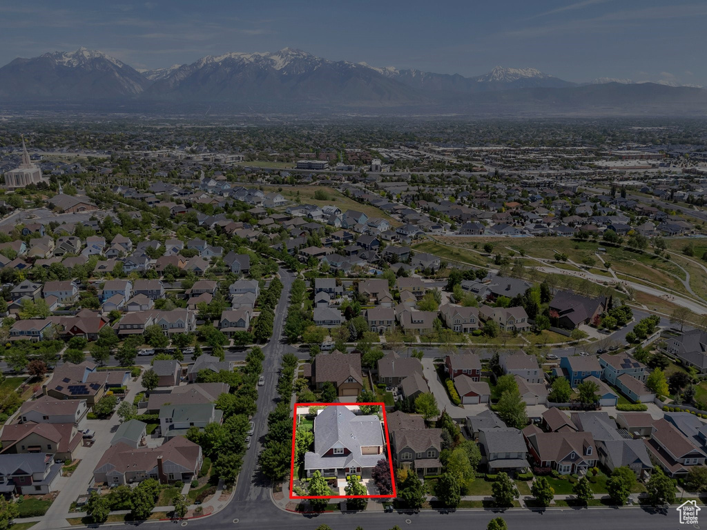 Aerial perspective of suburban area with a mountainous background and property boundaries highlighted