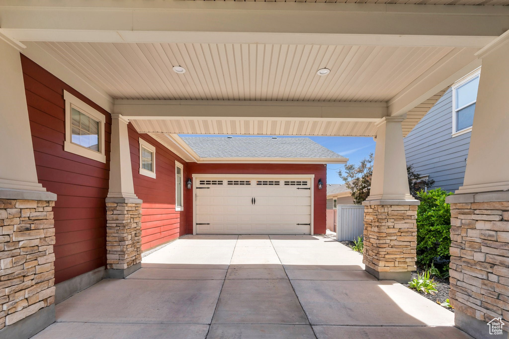 Garage featuring concrete driveway