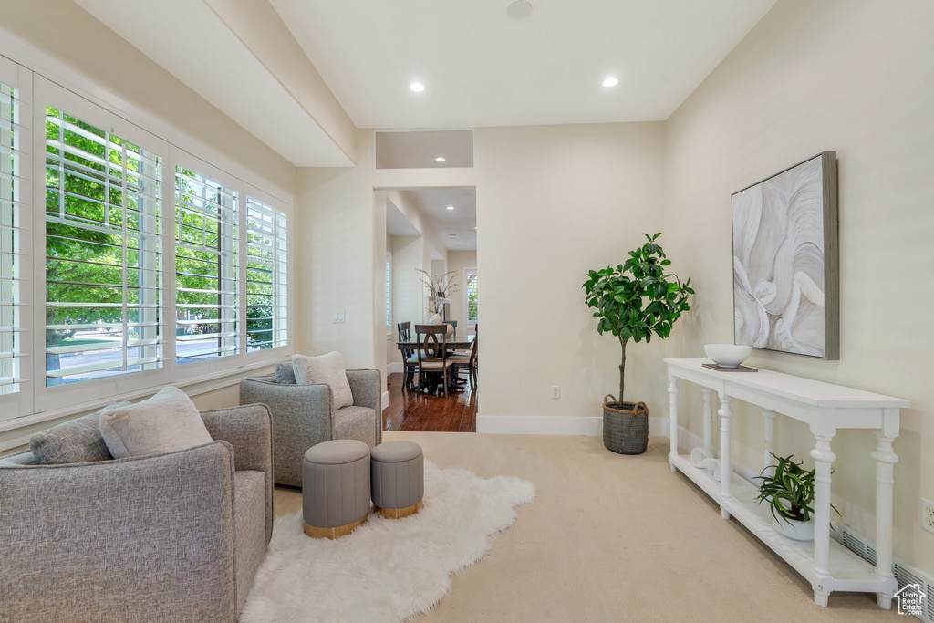 Living area featuring recessed lighting, baseboards, and carpet