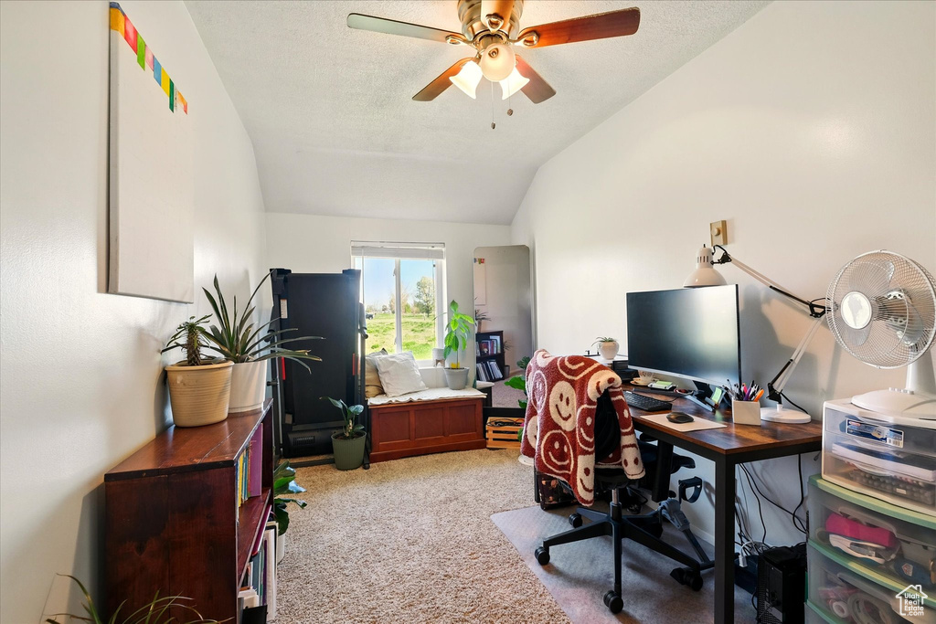 Office featuring vaulted ceiling, light colored carpet, and ceiling fan