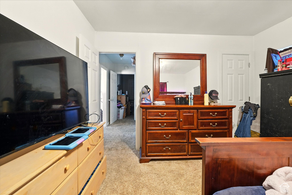 Bedroom featuring light colored carpet