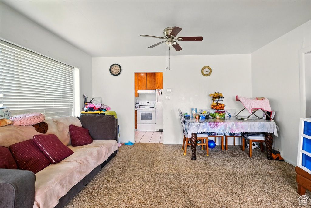 Living room with a ceiling fan and carpet