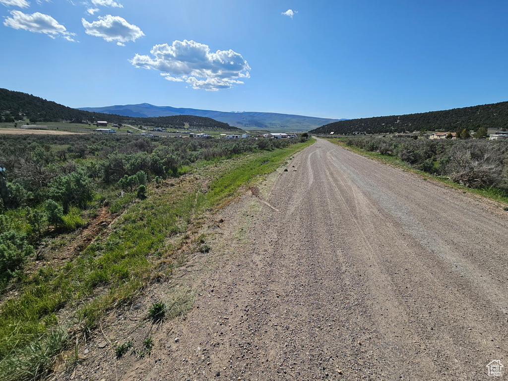 View of dirt / gravel road with a mountain view