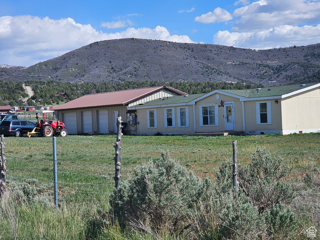 View of front of home featuring a mountain view and an attached garage