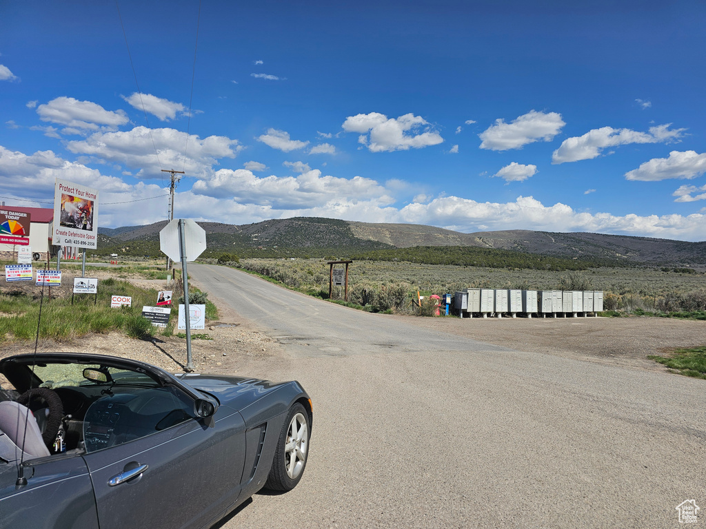 View of asphalt road with a mountain view and traffic signs