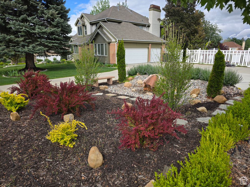 View of yard with fence and a garage
