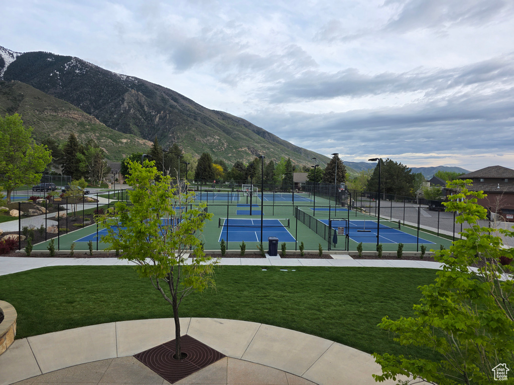 View of community featuring a tennis court and a mountain view