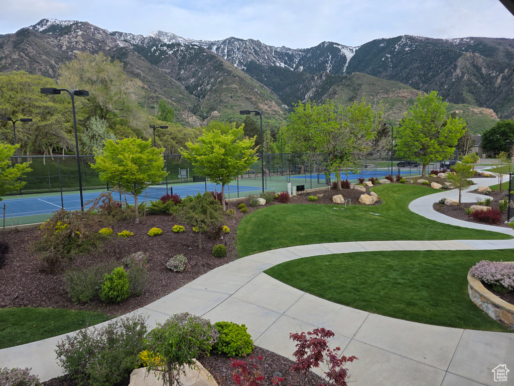 View of home\'s community featuring a tennis court and a mountain view