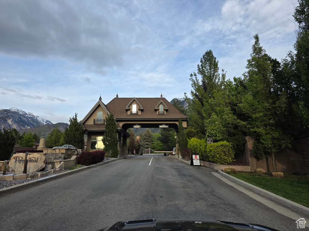 View of asphalt road featuring curbs and a mountain view