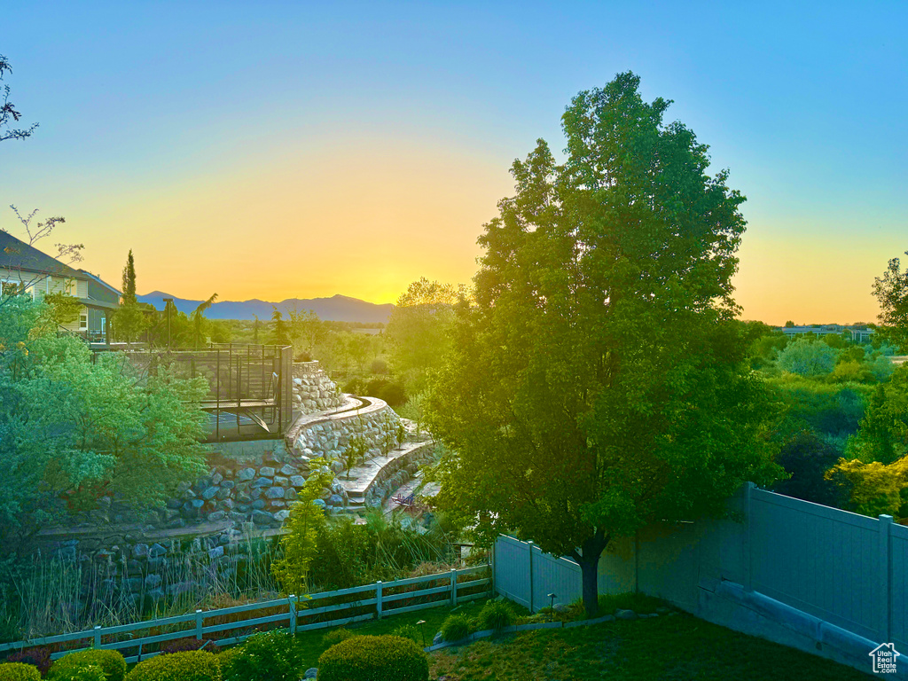 View of yard with fence and a mountain view