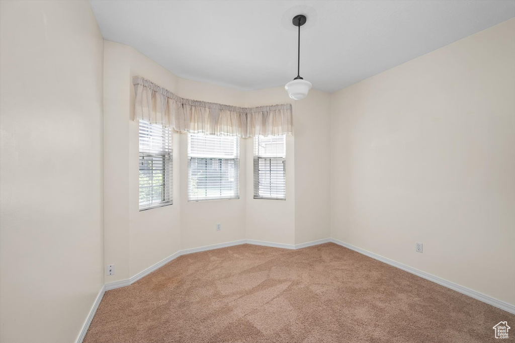 Carpeted empty room with baseboards