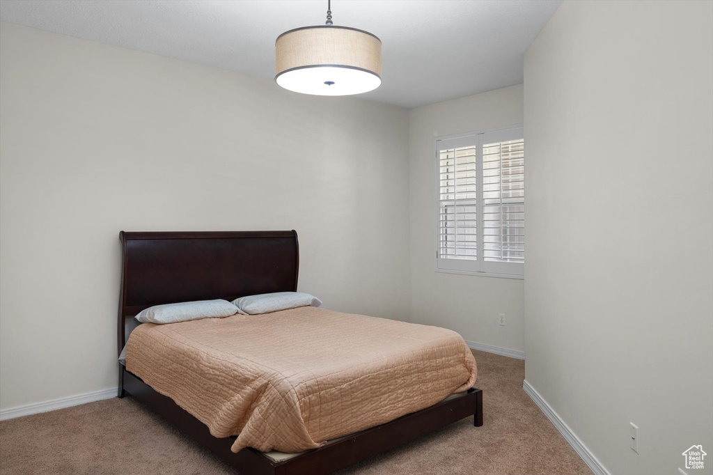 Bedroom with carpet flooring and baseboards