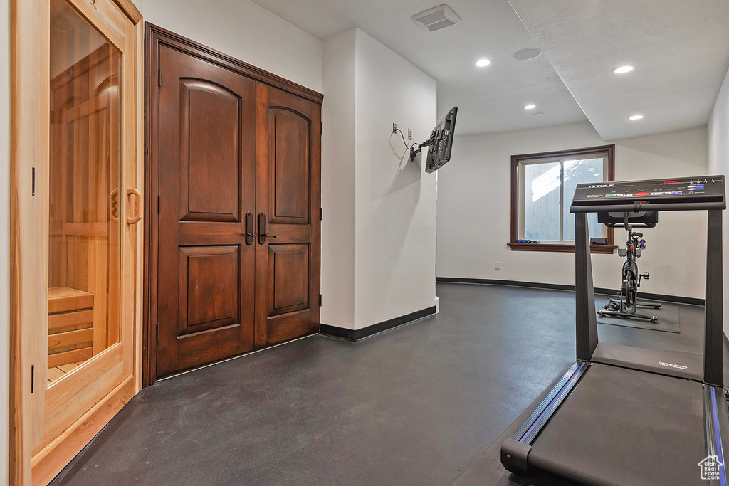Workout area featuring baseboards and recessed lighting
