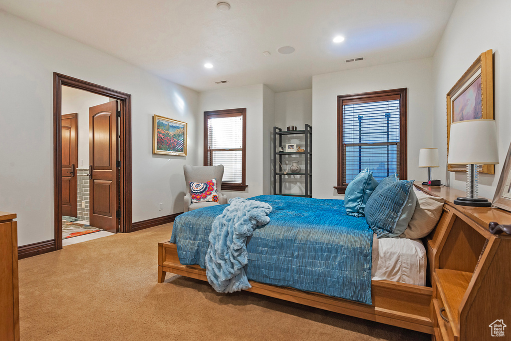 Carpeted bedroom with baseboards, recessed lighting, and connected bathroom