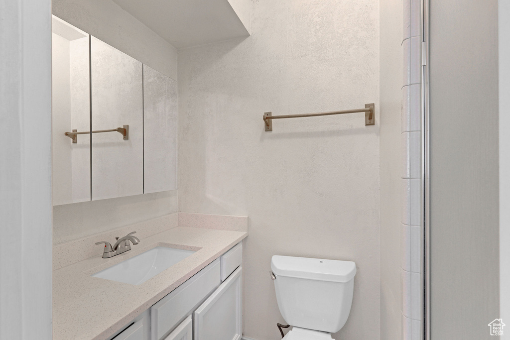 Full bath featuring toilet and vanity