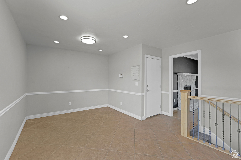 Tiled empty room featuring recessed lighting and baseboards