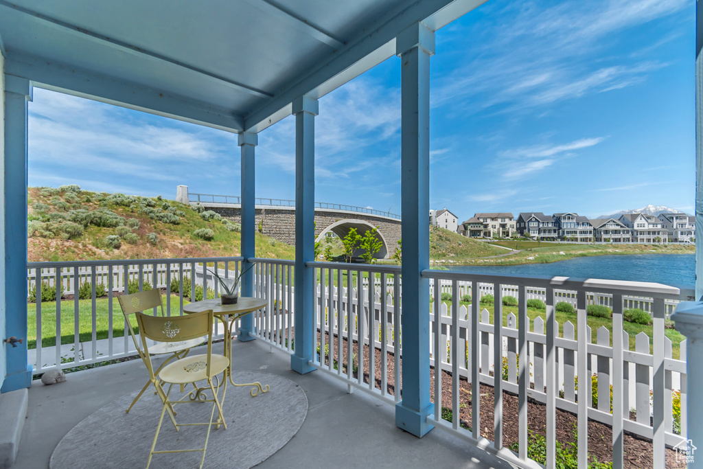 Balcony featuring a water view and a residential view