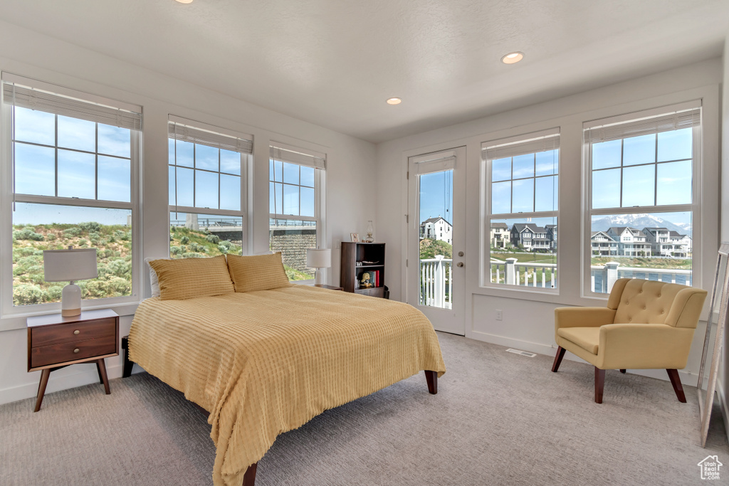 Bedroom with access to exterior, baseboards, light colored carpet, and recessed lighting