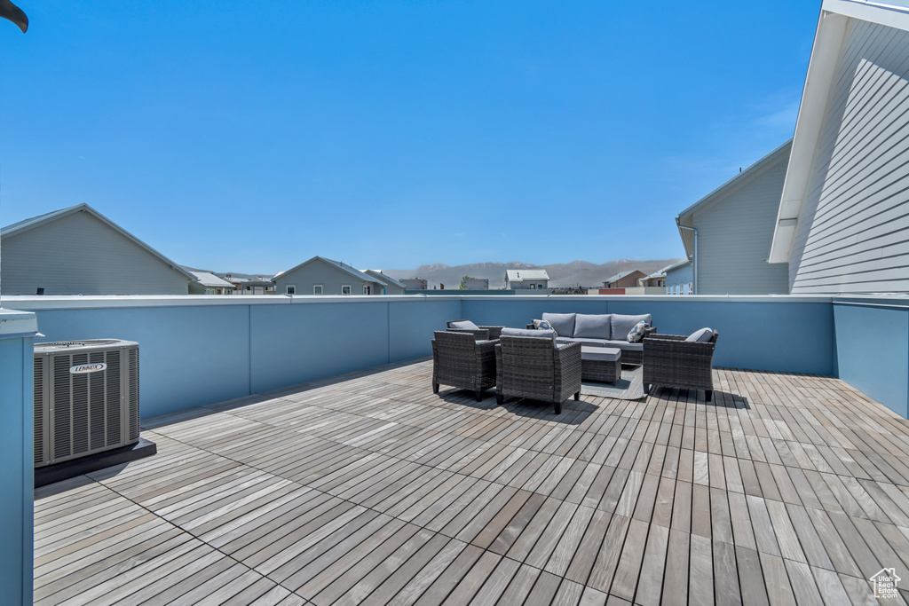 Wooden deck featuring central AC and an outdoor hangout area