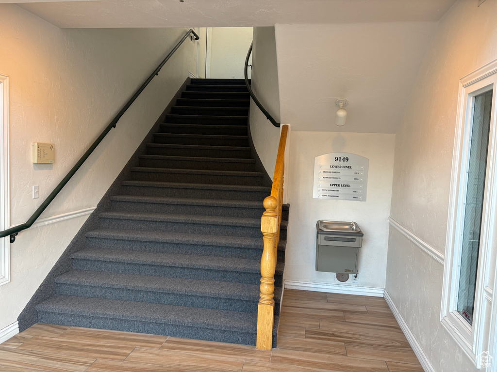 Stairway featuring wood finished floors and baseboards