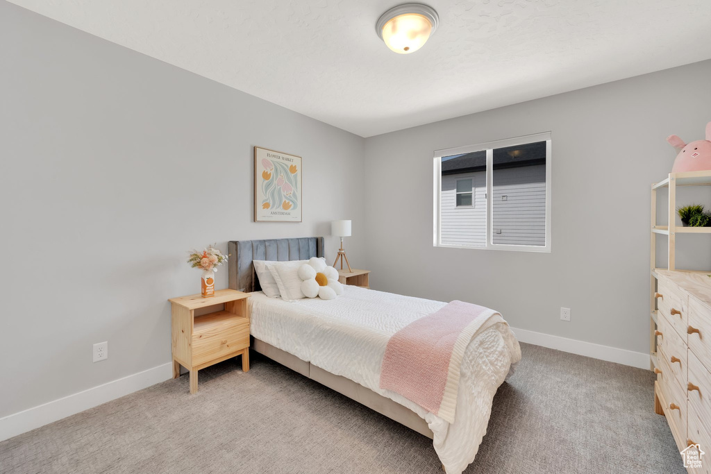 Bedroom featuring baseboards and light colored carpet
