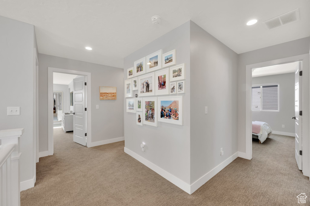 Hall featuring carpet, baseboards, and recessed lighting
