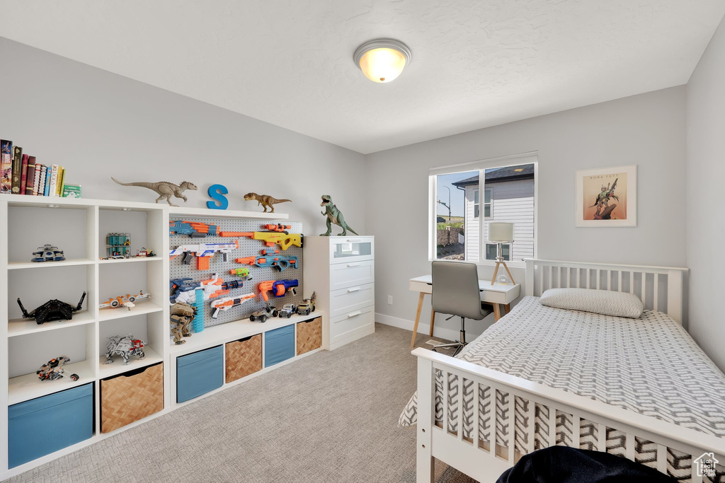 Carpeted bedroom with baseboards