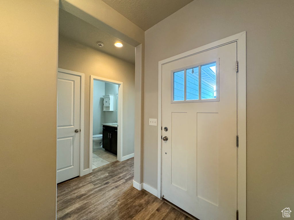 Foyer featuring wood finished floors, baseboards, and recessed lighting