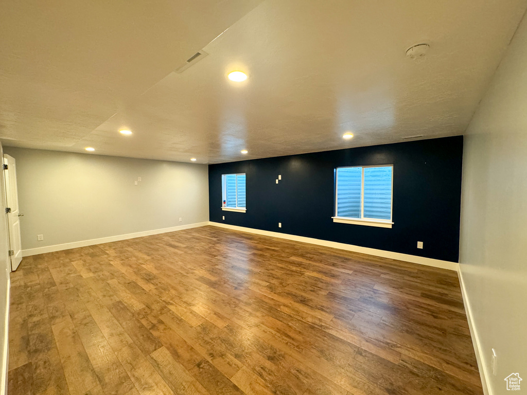 Unfurnished room featuring recessed lighting, wood finished floors, and baseboards