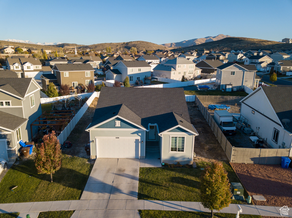 Aerial perspective of suburban area featuring a mountainous background