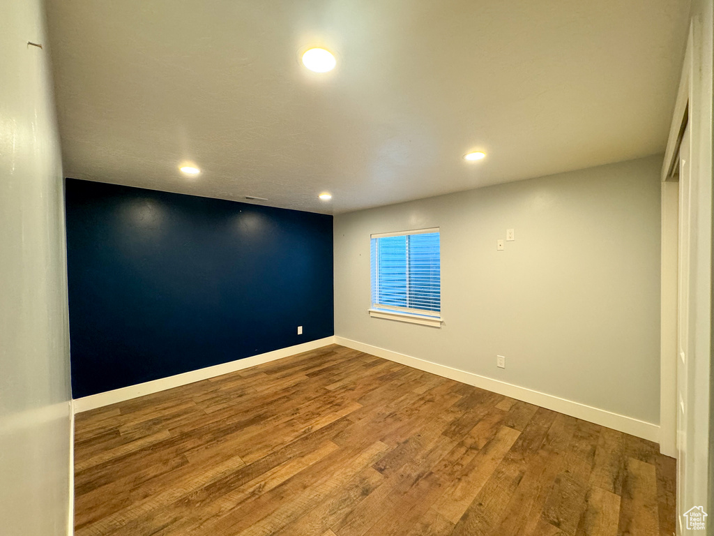 Empty room with recessed lighting, wood finished floors, and baseboards