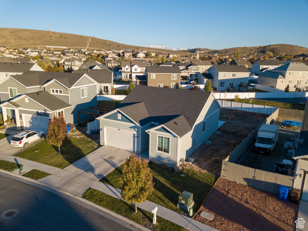 Aerial view of residential area featuring a mountainous background
