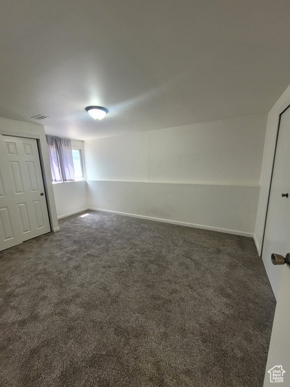 Unfurnished bedroom featuring carpet floors and baseboards