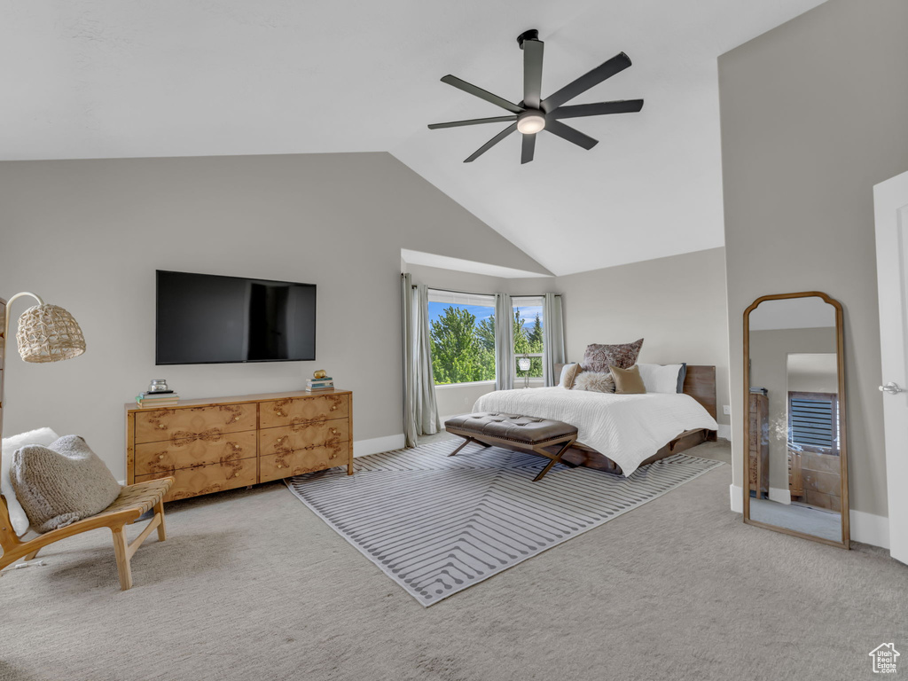 Carpeted bedroom featuring vaulted ceiling, baseboards, and a ceiling fan