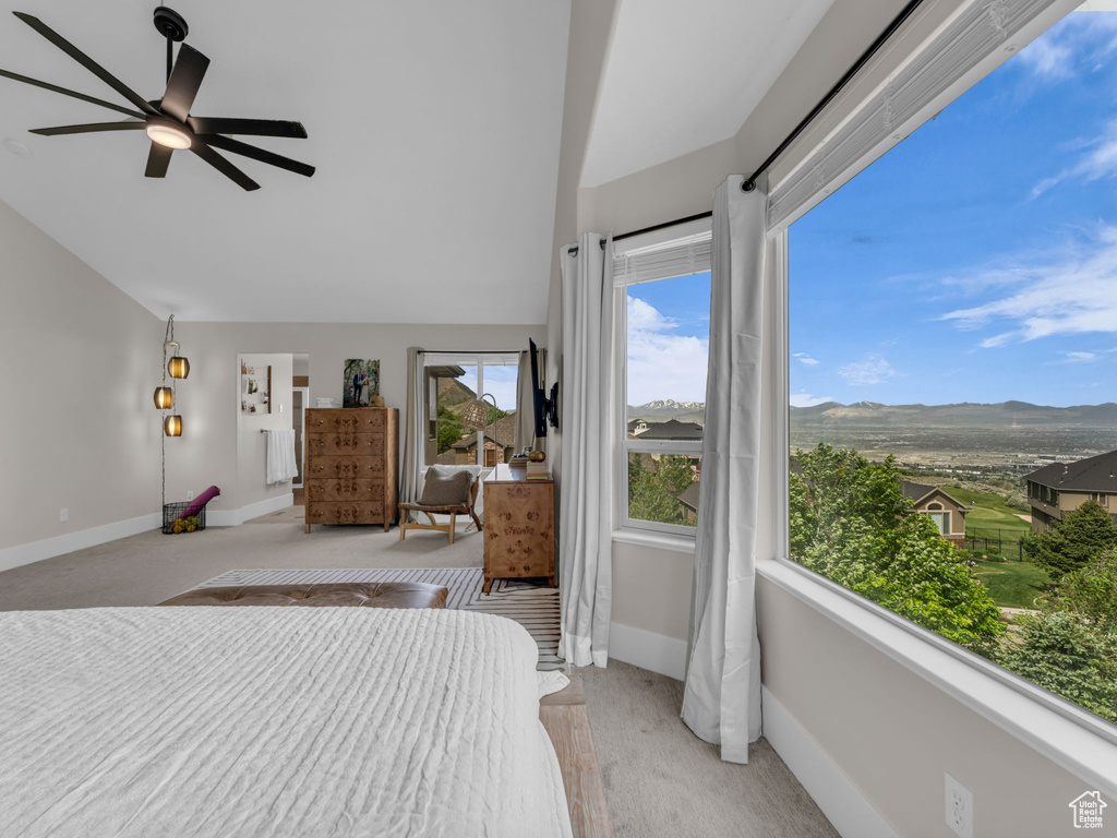 Bedroom featuring lofted ceiling, baseboards, a mountain view, and ceiling fan
