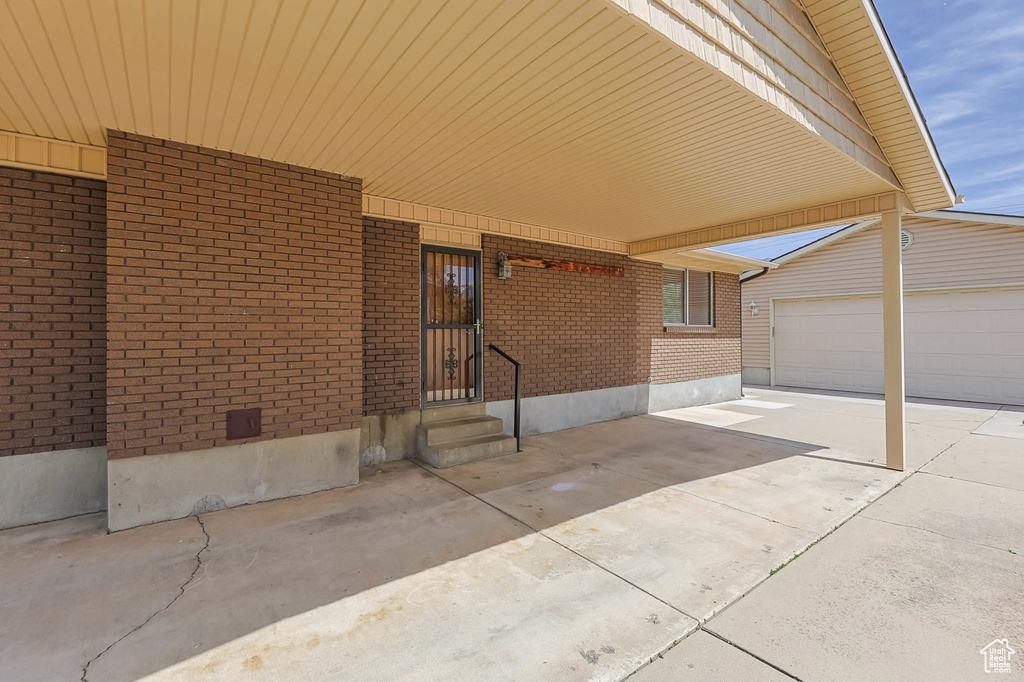 View of patio / terrace featuring a garage and driveway