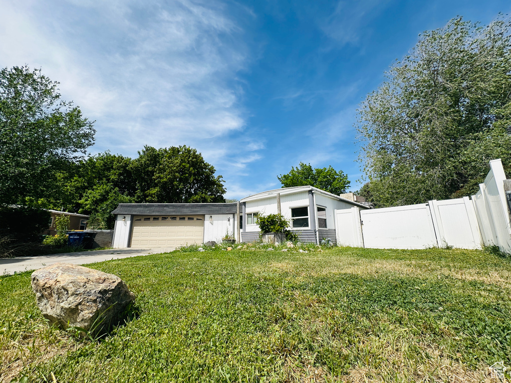 Mid-century inspired home with a garage and concrete driveway