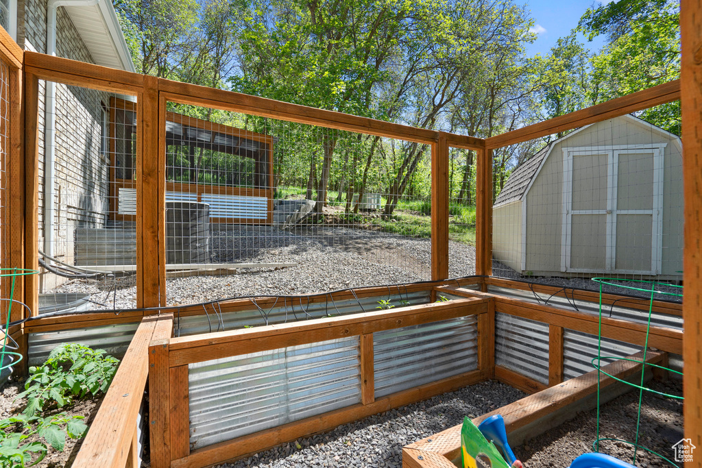 Wooden terrace with an outdoor structure and a storage shed