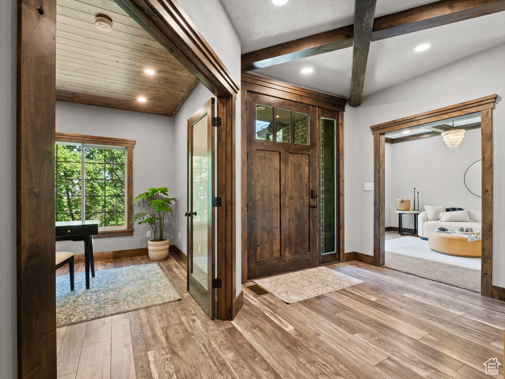 Entrance foyer with baseboards, light wood finished floors, and recessed lighting