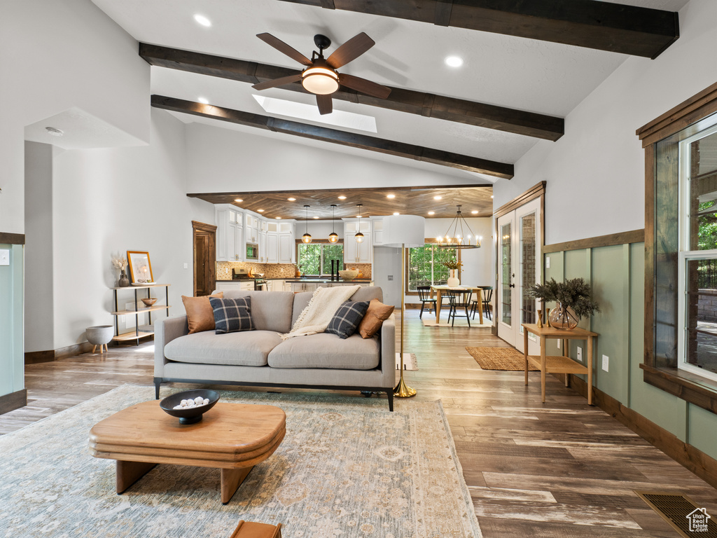 Living area featuring ceiling fan, light wood-type flooring, a chandelier, plenty of natural light, and recessed lighting