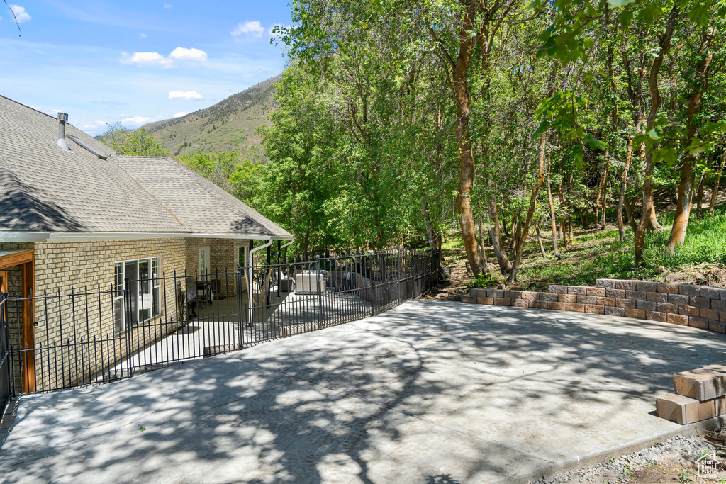View of patio / terrace with fence and a mountain view